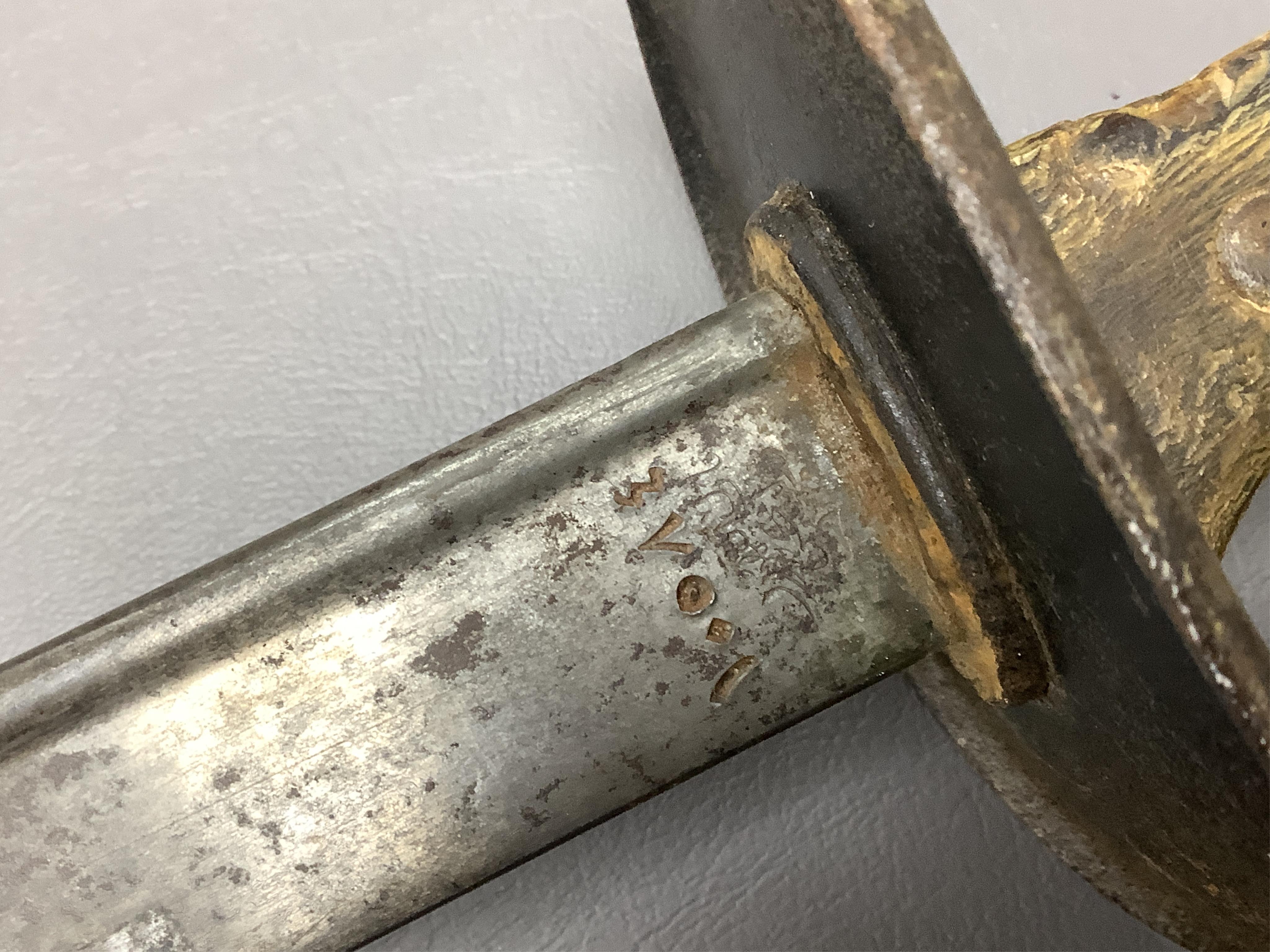 A First World War Turkish army officer’s sword, with pipe back blade, regulation iron guard pierced with crescent and moon, chequered horn grips, in its iron scabbard, together with an unidentified bayonet in its scabbar